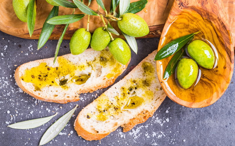 Olive oil and bread, olives top view.