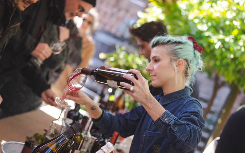 luni hill wine tasting, girl pouring some red wine