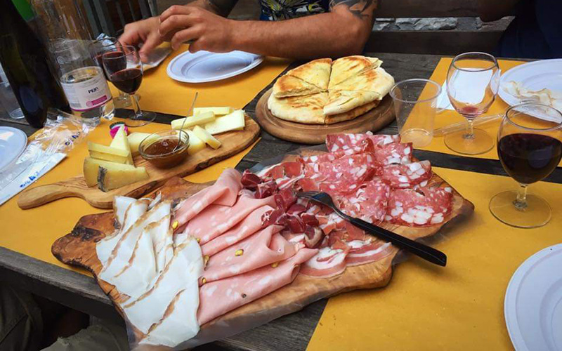 snack with focaccia, cold cuts, cheese, jam, wine