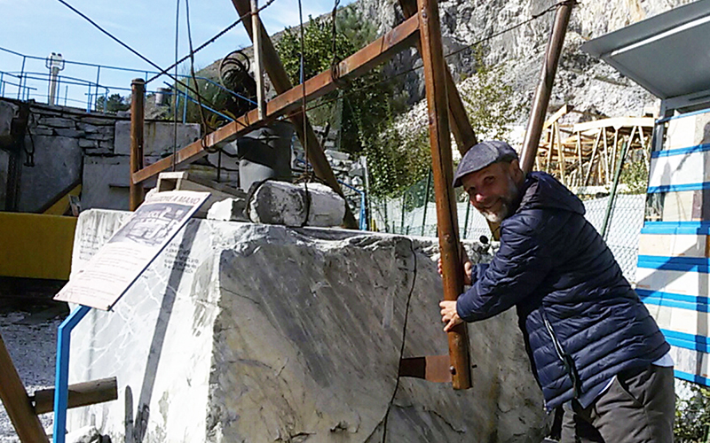 carrara marble quarriers art and culture. Umberto at work with hand saw in the quarry museum