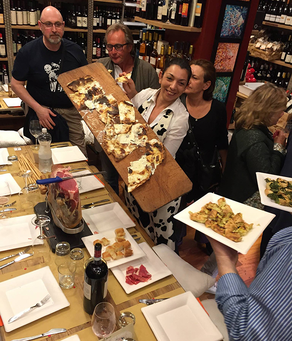 waitress offering some ligurian cheese foaccia