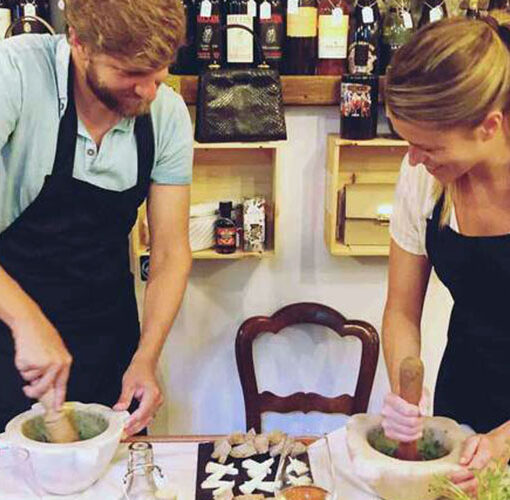 Two people making pesto by hands