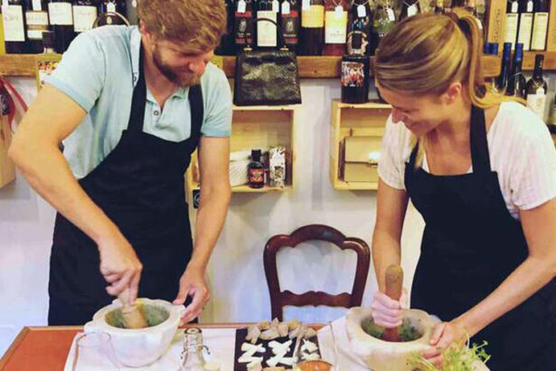 Two people making pesto by hands