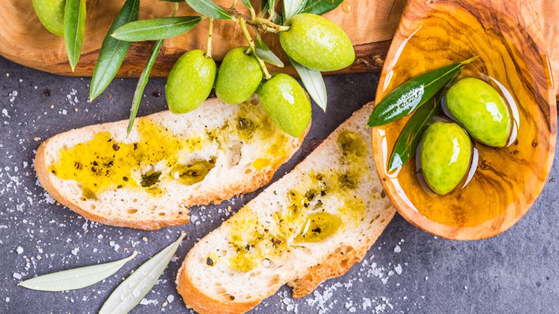 Olive oil and bread, olives top view.